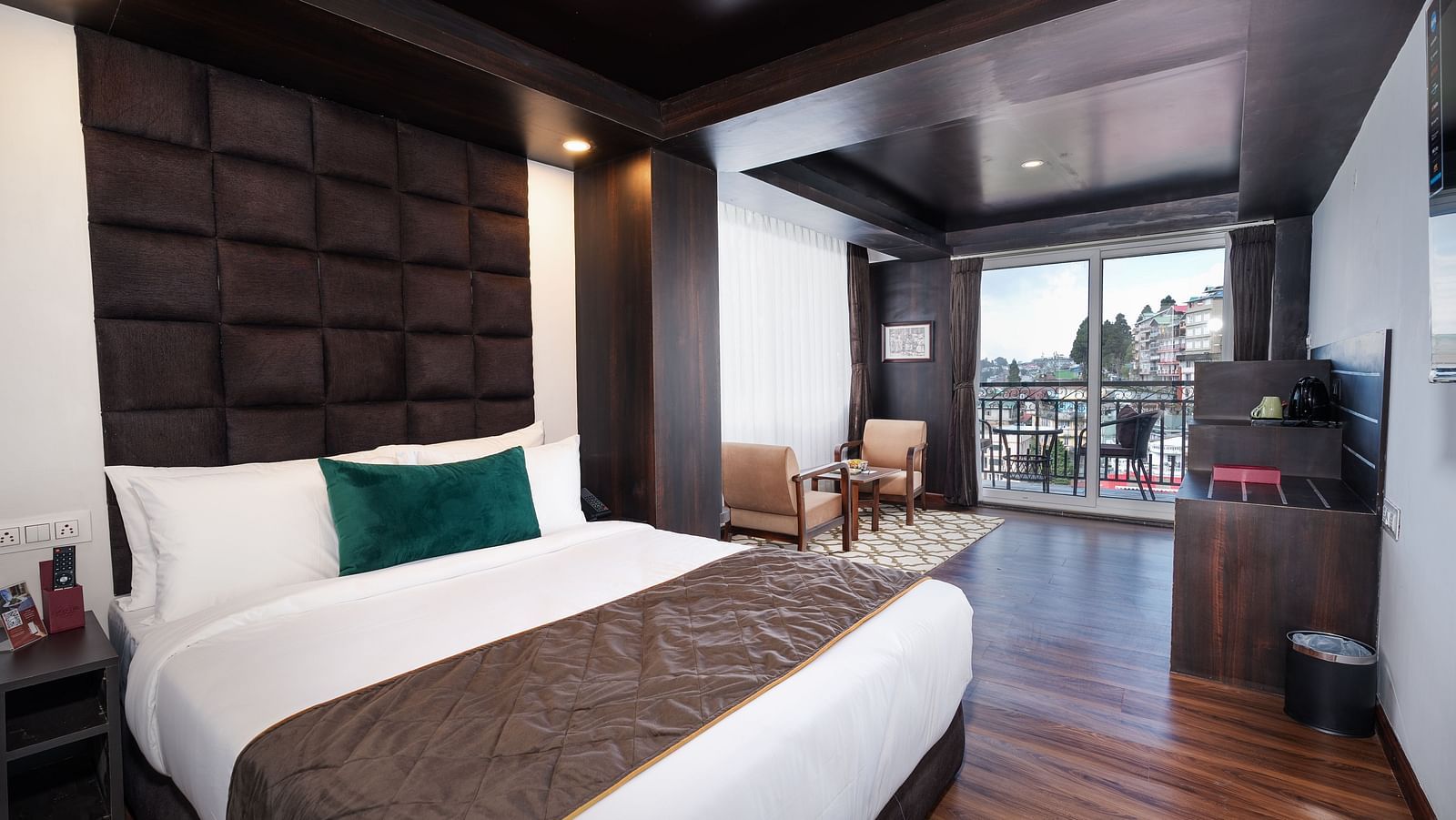 Image of a room that is well furnished with a king size bed and also has an access to a private balcony