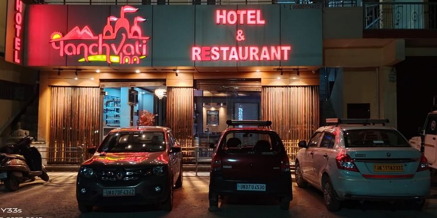 Facade of Hotel Panchvati Inn with cars parked outside