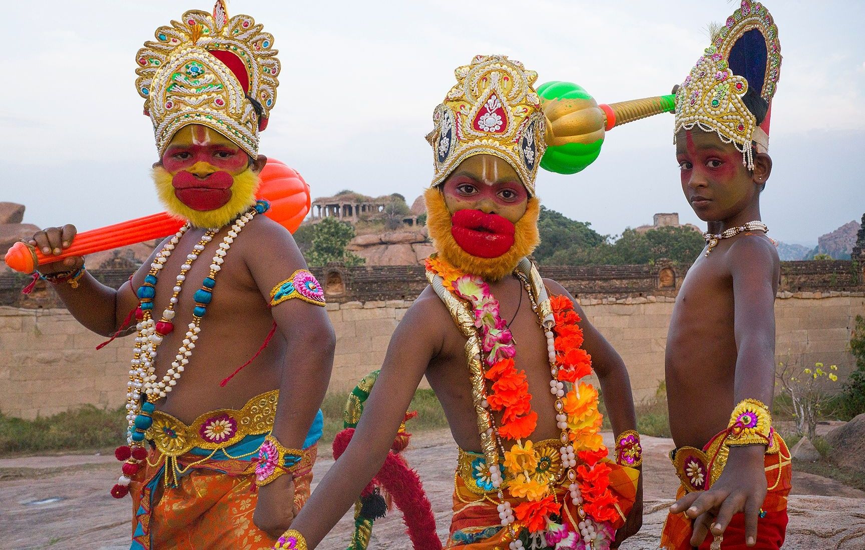 Three young performers in traditional Hanuman look in hampi