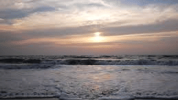 an image of a each with calm waves during the day