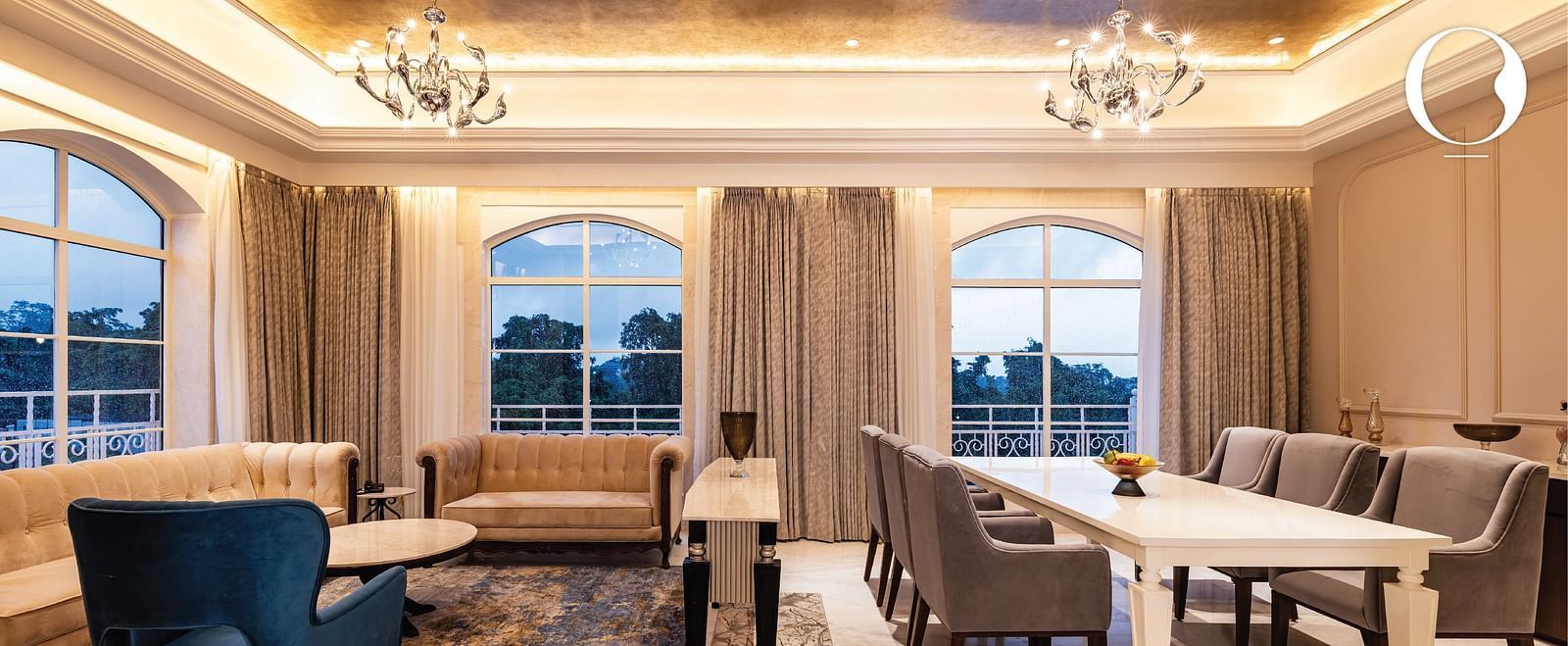 An expansive living area featuring a seating area along with a dining area at the Miros Hotels.