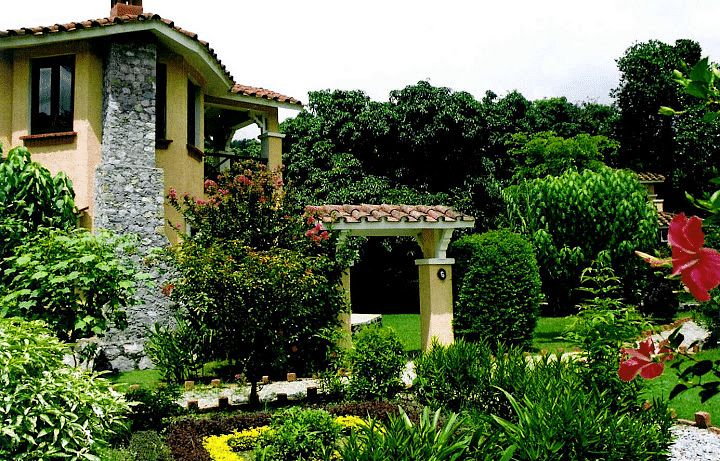 Facade of a Luxury villa with a garden in background