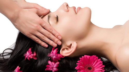 A woman receiving a massage at the spa inside The Retreat Hotel and Convention Centre