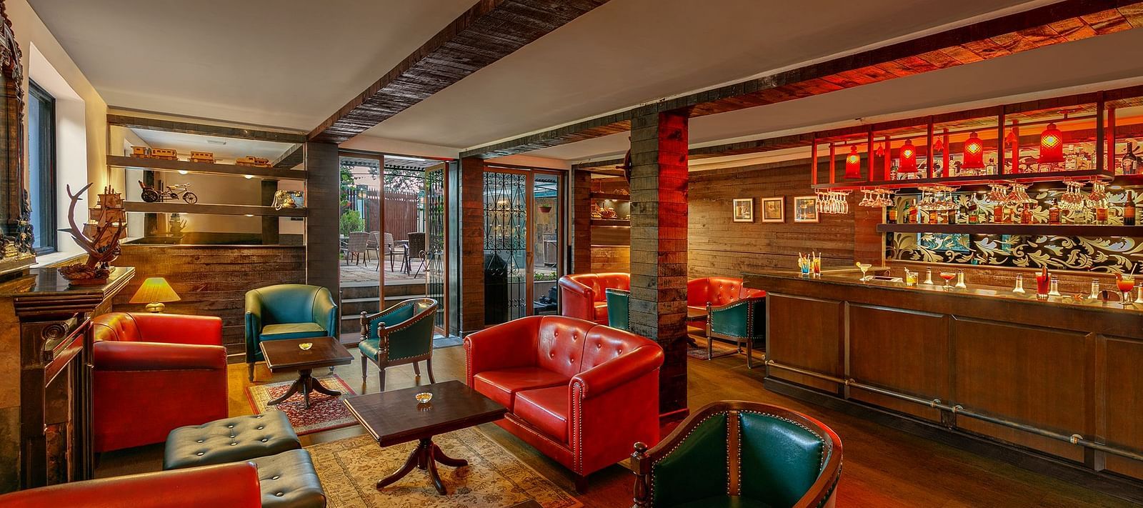  A image of a resturant with tred lighting with table and chair setting well decorated with bar also present at Shervani Hiltop 