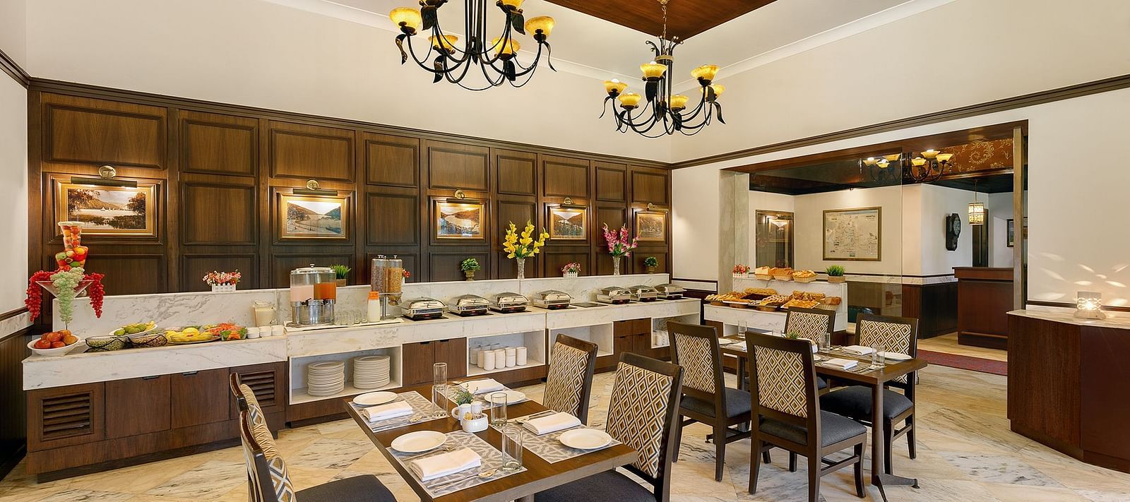 A resturant image well lit with table and chair and well decorated with Shervani Hilltop at Nainital 