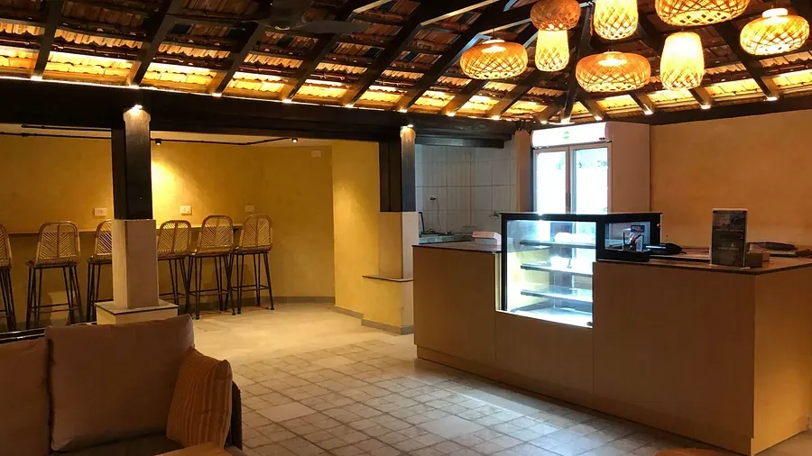 A communal space with a counter and a seating capacity at Indie Stays Resort, Goa.