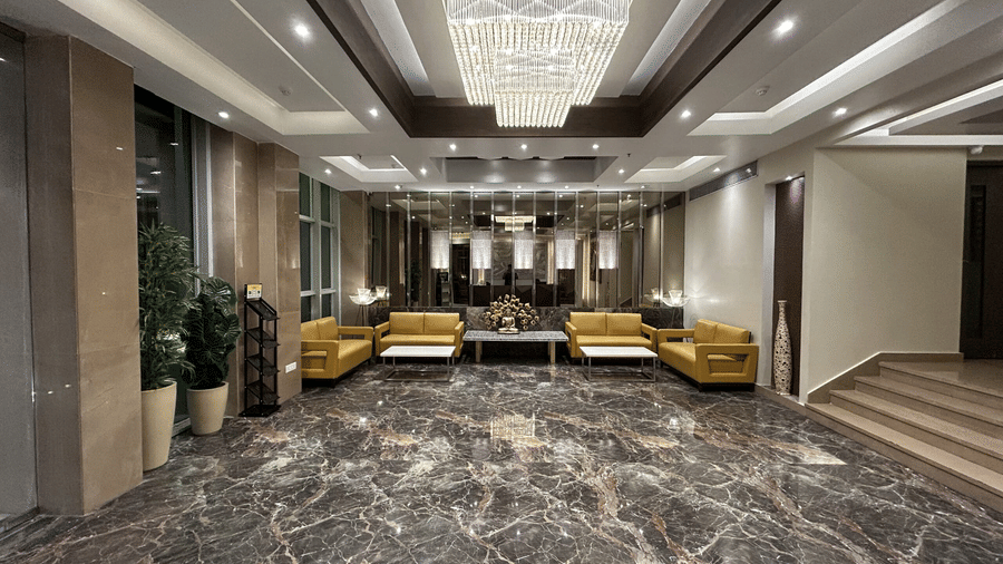 Reception of Sand Heaven, Port Blair featuring large lobby area with multiple sofas arranged at the far end.