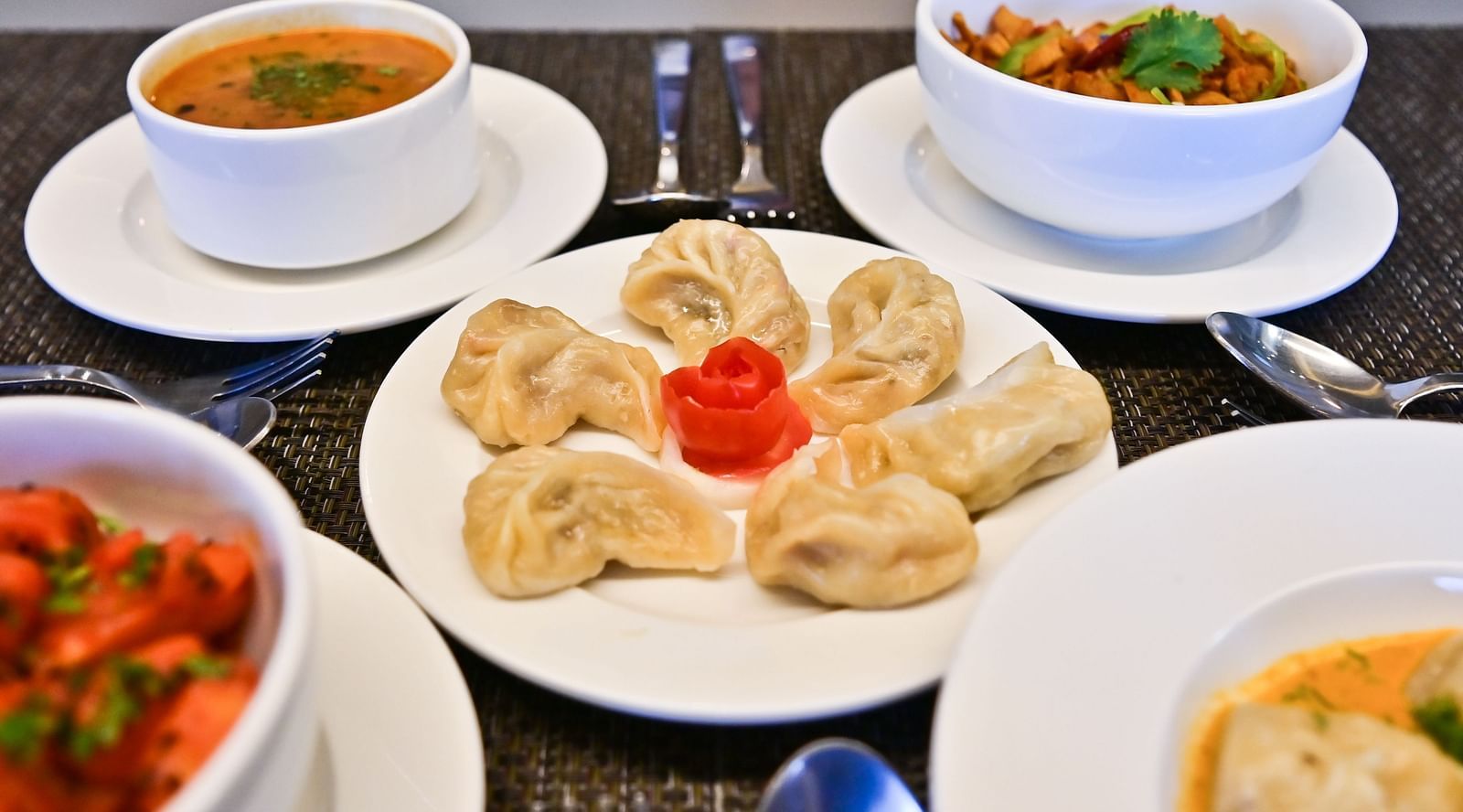 Front view of variety of dishes set on the tables at The Soma Hotel by Avianna Group, Darjeeling