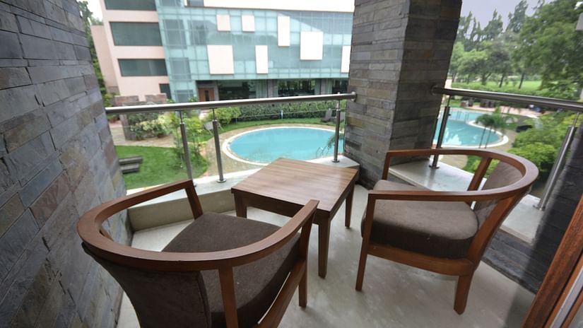 Balcony seating area with wooden chairs