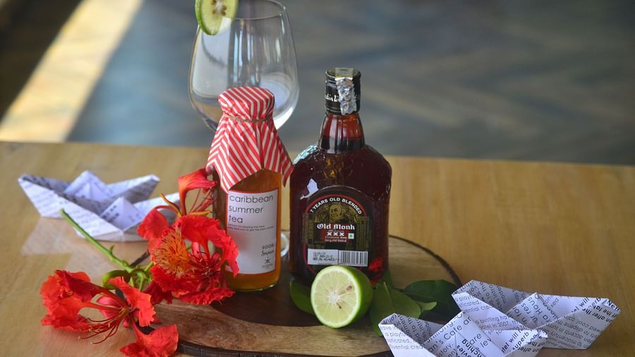 a bottle of old monk and a cocktail mix kept on a glass table - polo floatel kolkata