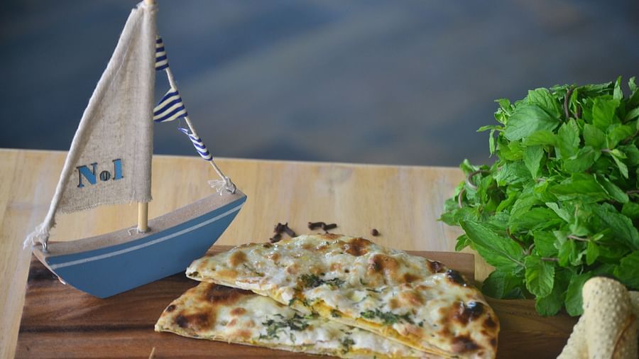 two slices of pizza kept on a wooden board - polo floatel kolkata