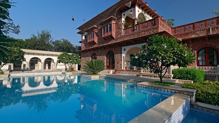 Side view of a haveli with open courtyards, verandahs, and a pool next to it - Khas bagh, Jaipur