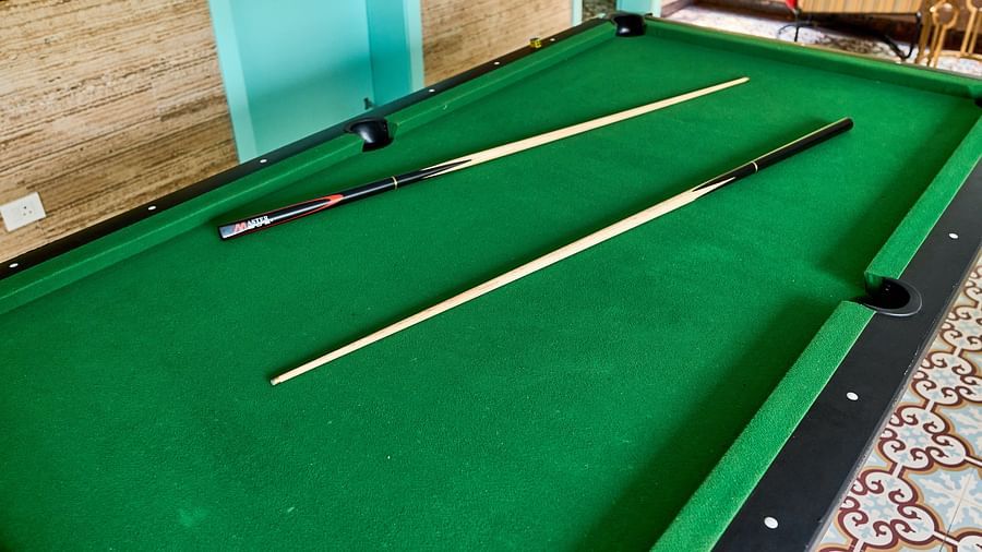  The pool table is set with two cues placed on it at Mayfair Manor, Alibag