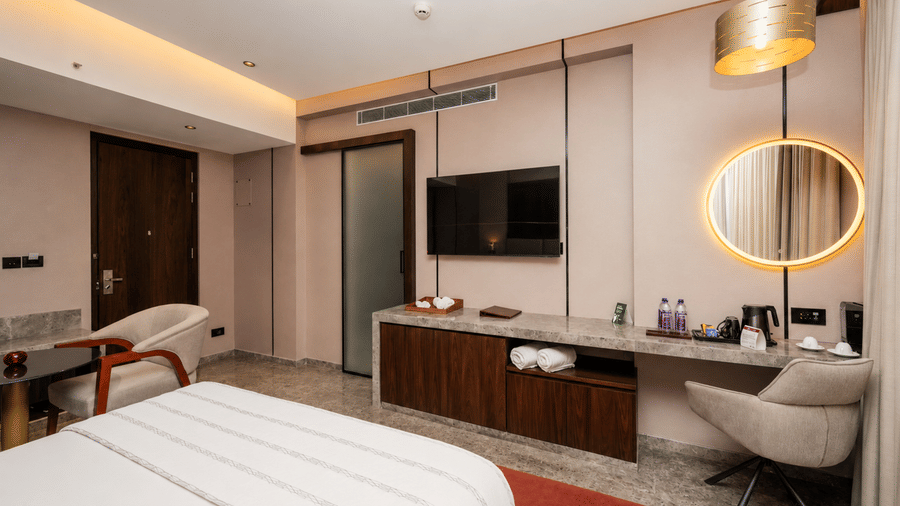 Bedroom view showing workstation circular illuminated mirror and TV at Ni Central Park.