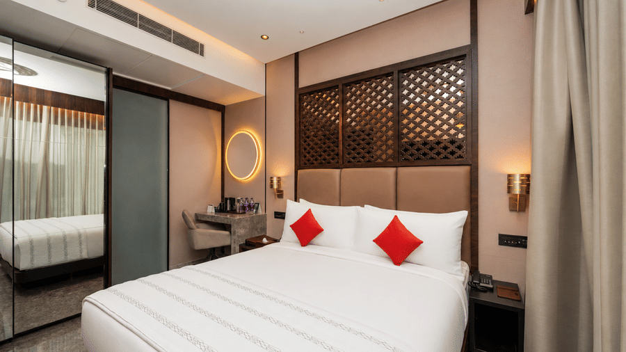 Loom Room with king bed smart lighting and warm interior accents at Ni Central Park, Mysuru.