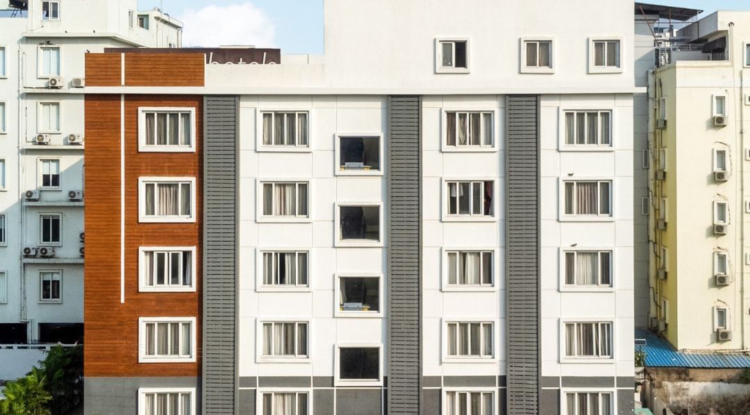 Facade of Destino by Monday Hotels featuring a multi-storey building under a partly cloudy sky.
