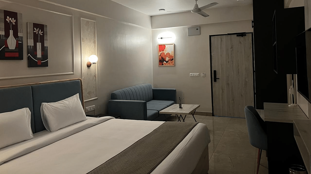 Studio Premium  King RA spacious room featuring a large bed, furniture near the wall, and a wall-mounted TV opposite the bed at Urban Suites by BluSalzz, Jaipur.oom