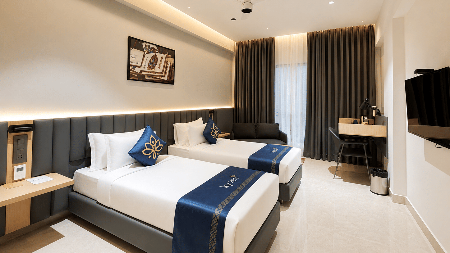Premium Suite with two twin beds and a wall mounted television at Hotel Kyzen, Shamshabad Airport, Hyderabad.