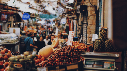 An image of a crowded market where people are seen shopping