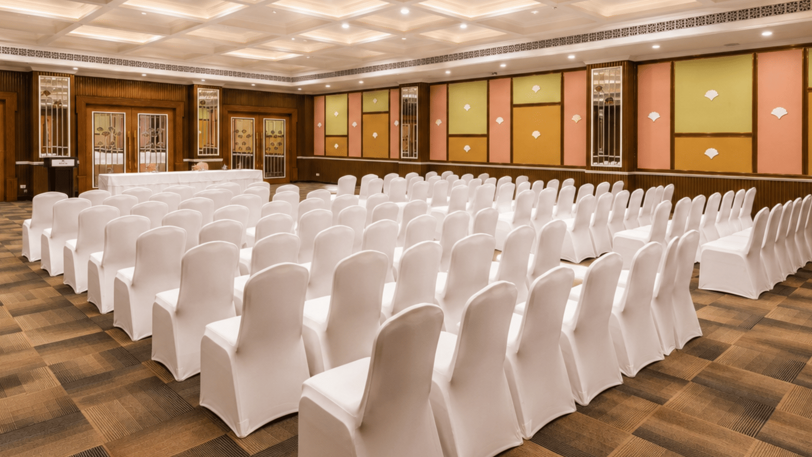 Banquet-style conference hall with white chairs at MAYFAIR Palm Beach Resort, Gopalpur-on-Sea