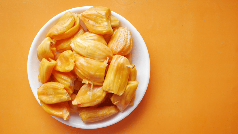 A plate full of jackfruits kept on a yellow background.