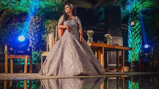 a woman in her wedding gown posing in nighttime at Themis Mudhouse Resorts