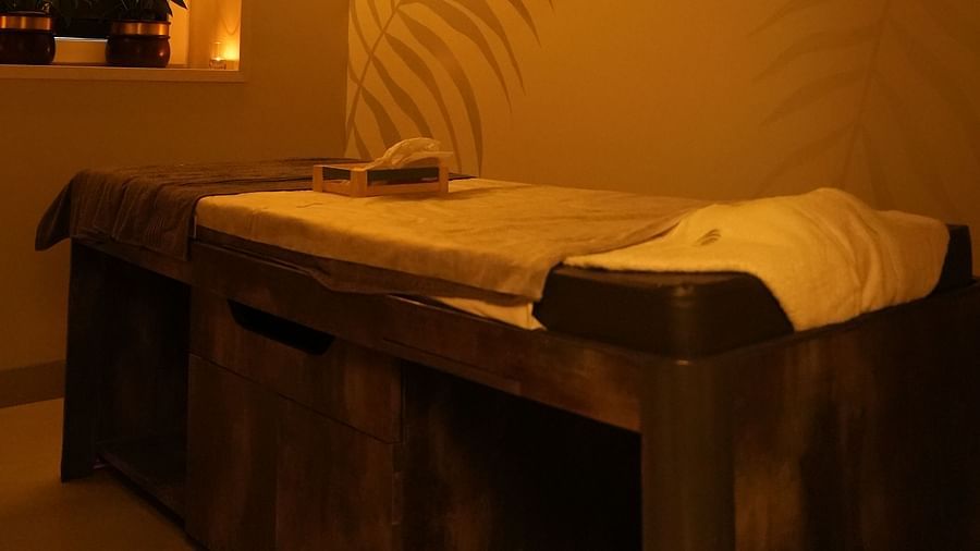 a massage bed inside the massage area with led lights - IOSIS Spa & Wellness