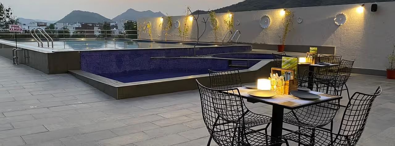 Pool and mountain view, outdoor table setting, evening.