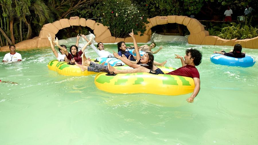 Water Kingdom - a group of people enjoying themselves on inflated tubes at Adventure Amazonia during daytime