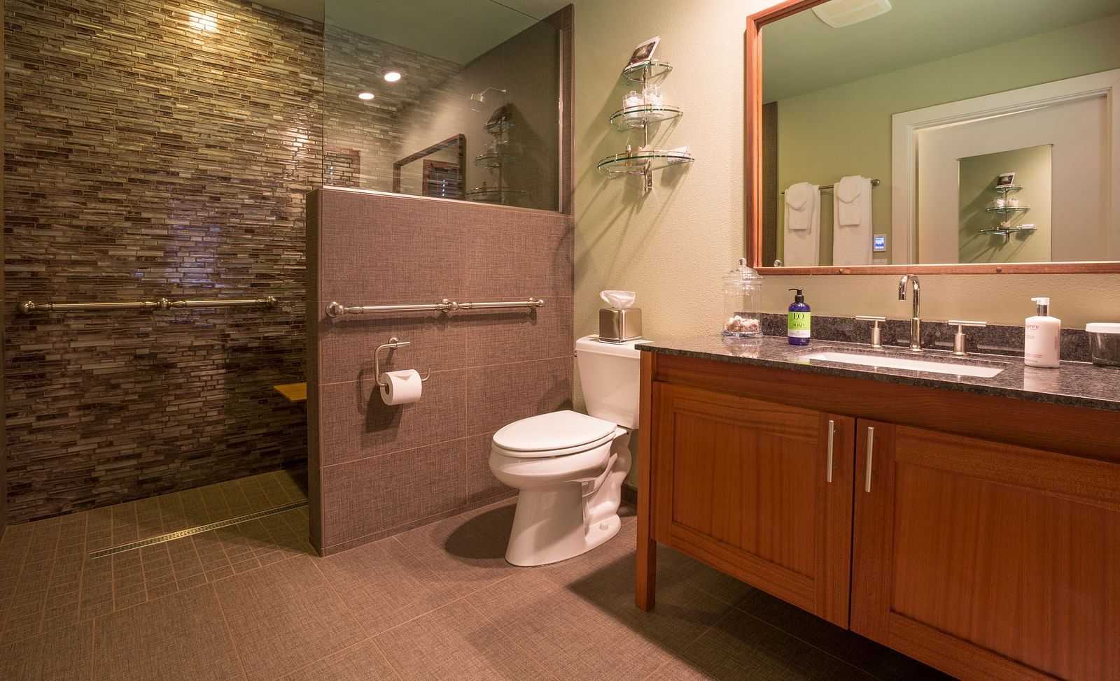 A modern bathroom with sleek design, a shower area, a commode and contemporary fixtures, offering a sophisticated experience - Brewery Gulch Inn & Spa