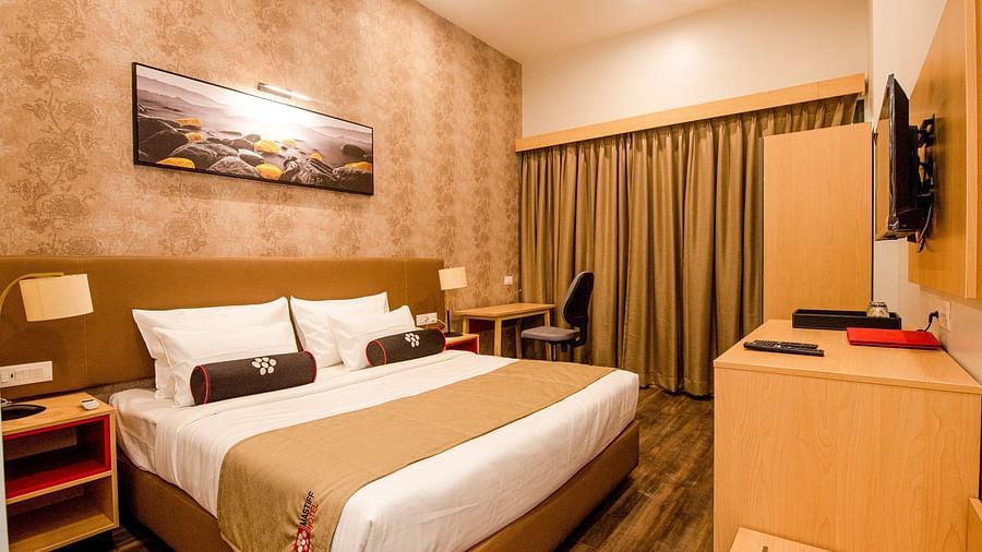 closer view of premier room with king size bed in a room with beautiful wooden furniture - Mastiff Hotel, Ankleshwar