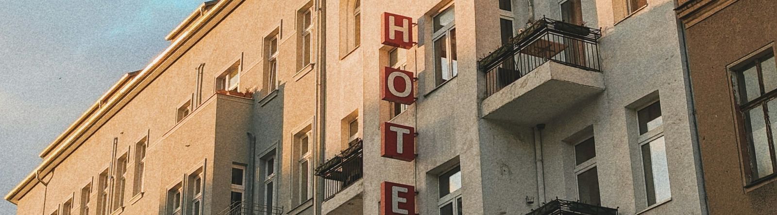  A low-angle view of a row of European-style buildings with balconies under a blue sky