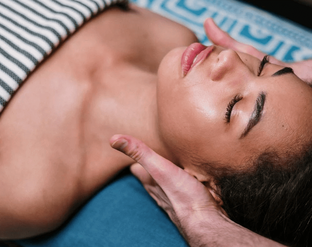 A woman getting her neck massage in a spa.