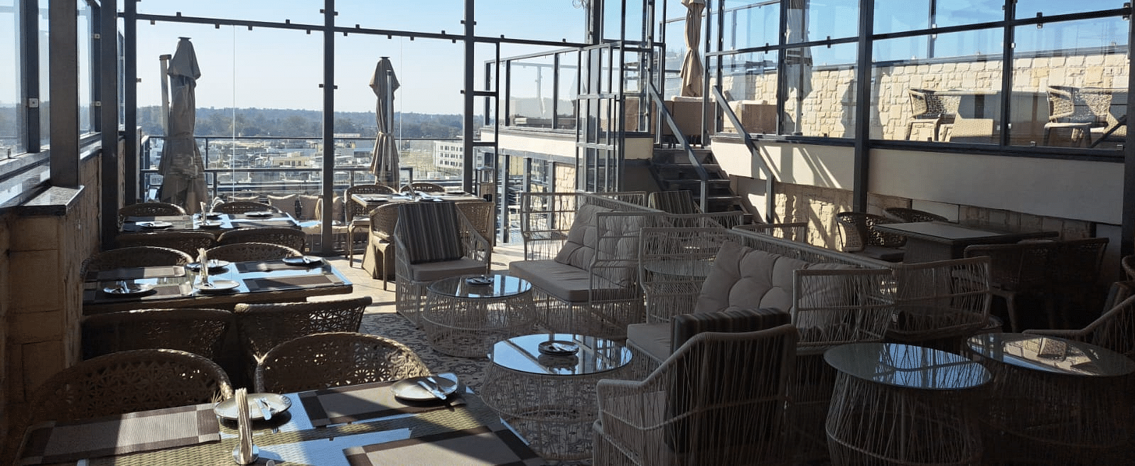 Interior view of lounge area with chairs and tables, BluSalzz Residence, Amritsar.