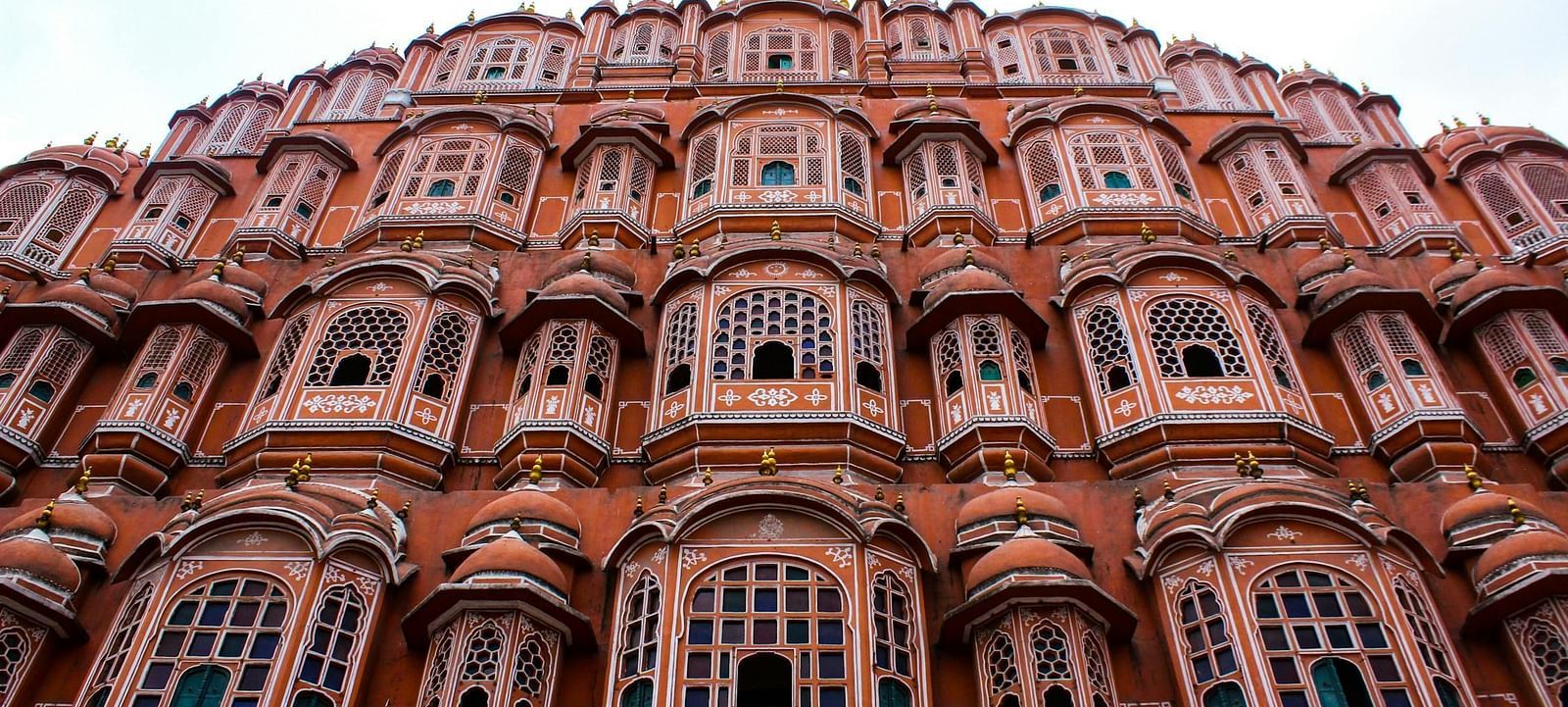 View of Hawa Mahal Palace with intricate latticework and jharokhas.
