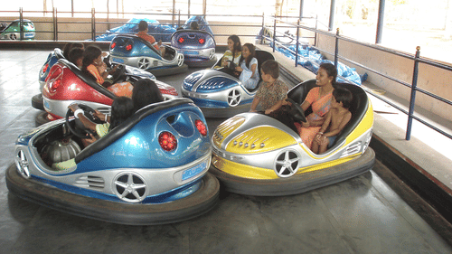 Bumper cars with sleek, colorful designs, where riders compete to bump into each other inside an indoor arena - The Black Thunder