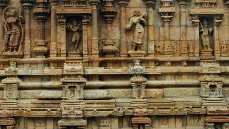 Detailed stone carvings and sculptures on the walls of a temple.