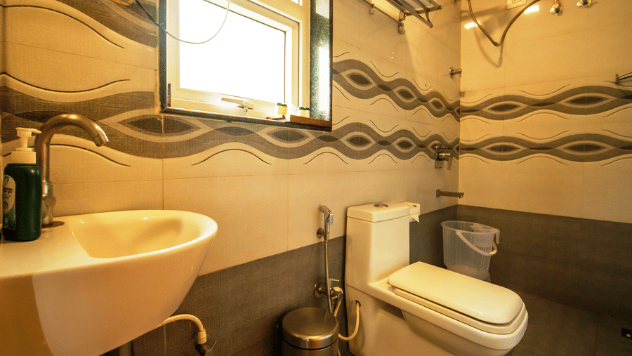 Image of a washroom with a sink and a toilet at Coorg Jungle Camp Backwater Resort, Kushalnagar.