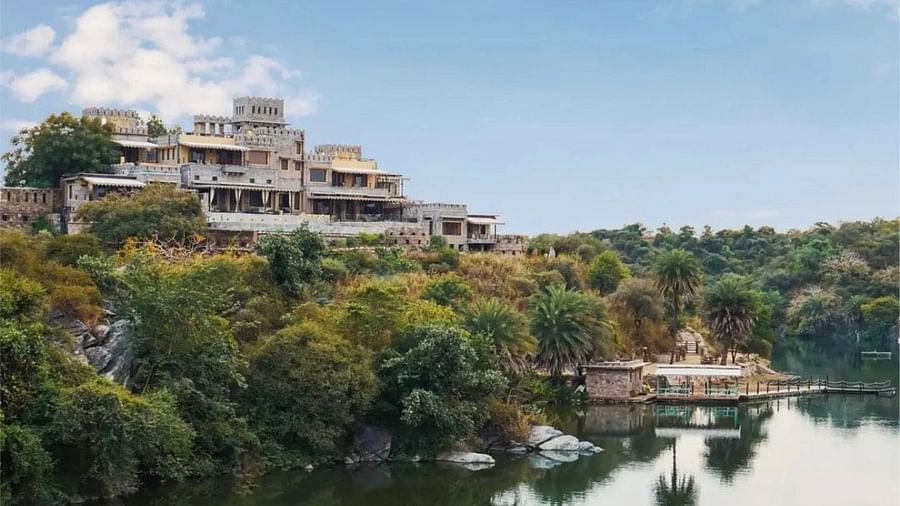 Facade of Chunda Shikar Oudi, Udaipur that is covered by forest area and the river in front of it