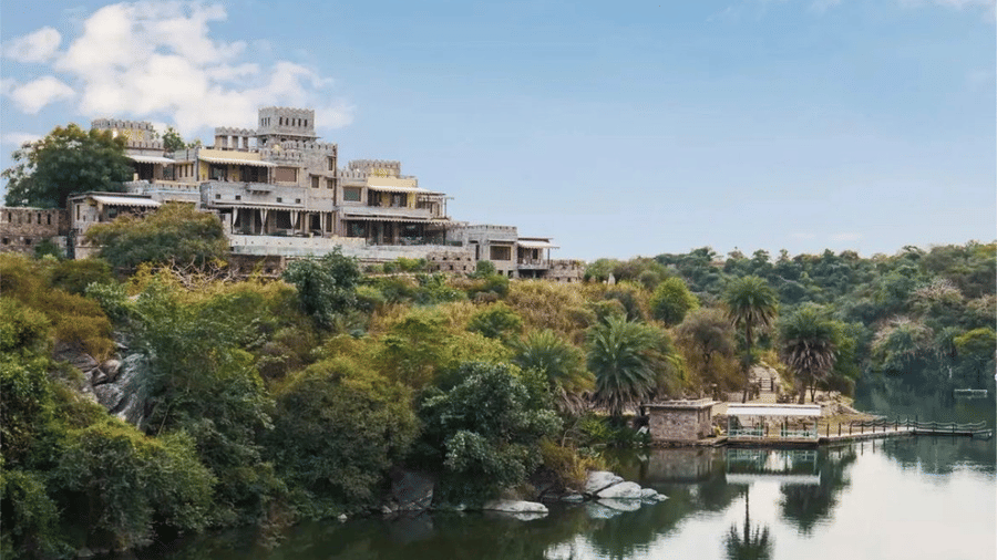 Facade of Chunda Shikar Oudi, Udaipur that is covered by forest area and the river in front of it
