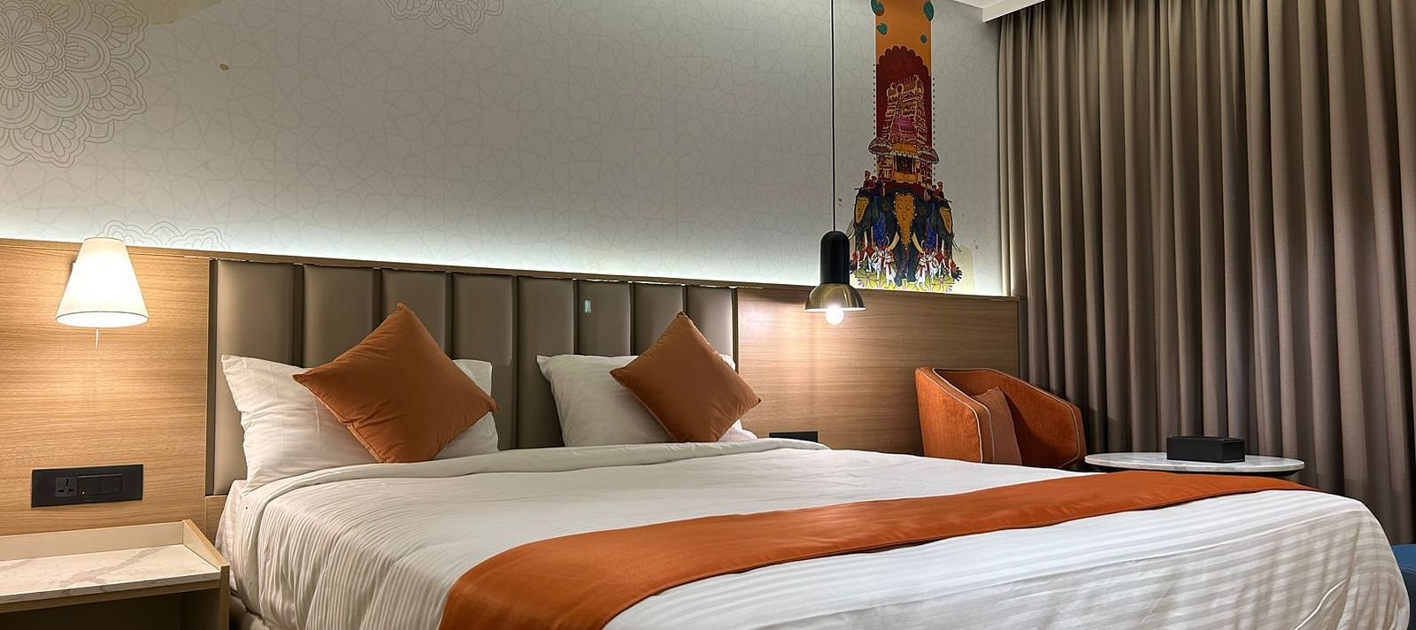 A room featuring a bed, bedside tables, and lamps - TGI Oberon, Koramangala