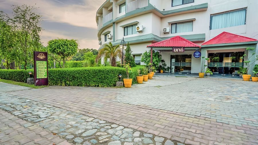 Facade of The Tattwaa Corbett Spa & Resort with landscaped surroundings.