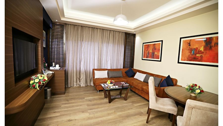 the living area with a TV and sofa sets at Executive Suites in Visakhapatnam