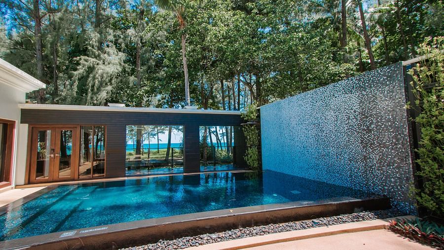 image of a personal open air swimming pool amidst lush green trees - one bedroom private pool beachfront villa
