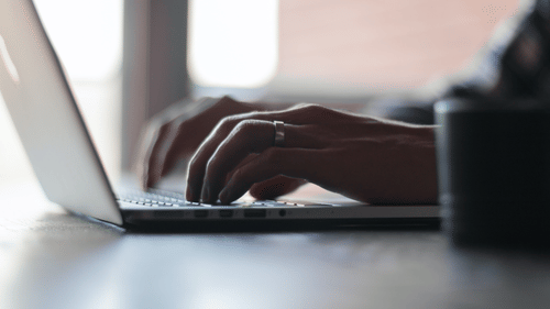 a person typing on a laptop