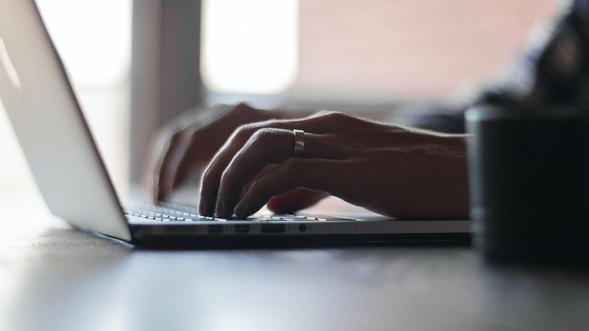 a person typing on a laptop
