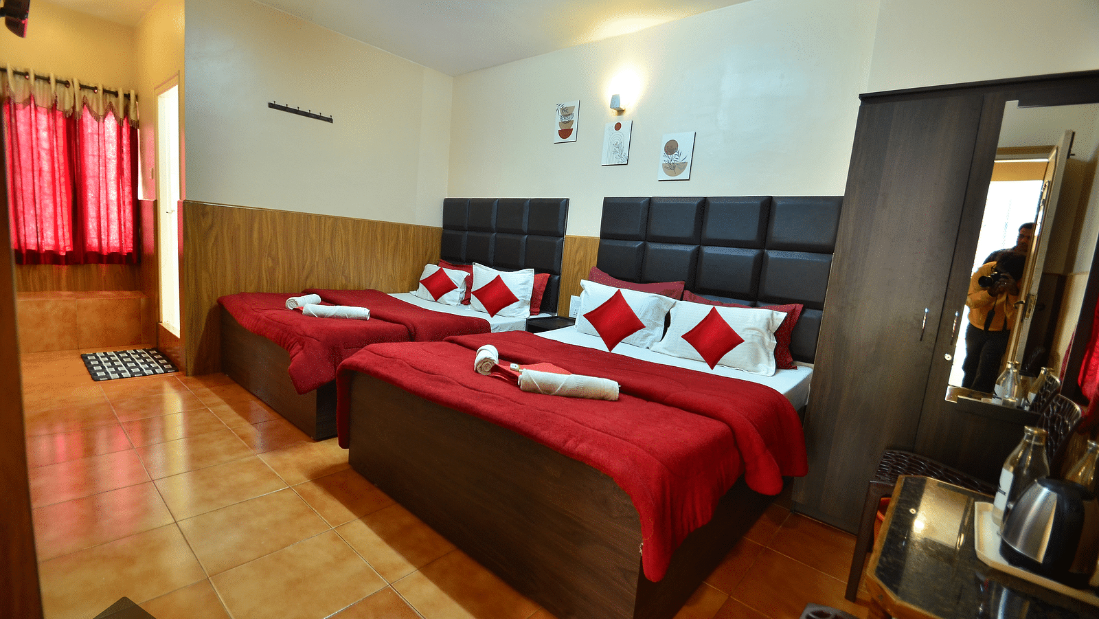 Image of a room with two beds and a wardrobe in the corner at BN Tourist Home.