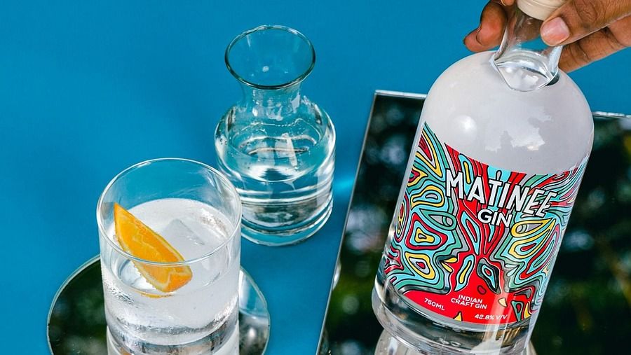 The banner shows a person holding a bottle of Matinee Gin next to two glasses
