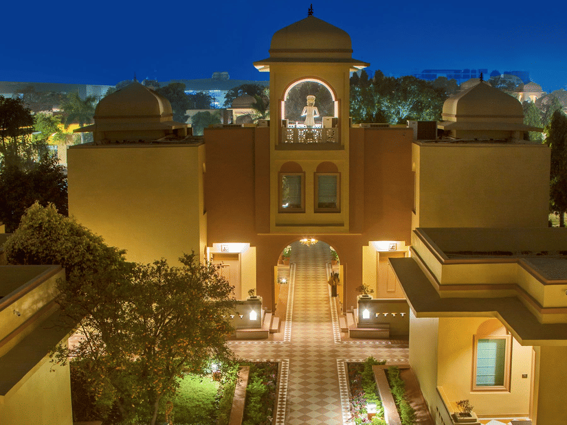 A beautifully illuminated courtyard of Heritage Village Resort & Spa, Manesar, one of the luxury resorts in Gurgaon, with elegant Rajasthani-inspired architecture and landscaped surroundings.