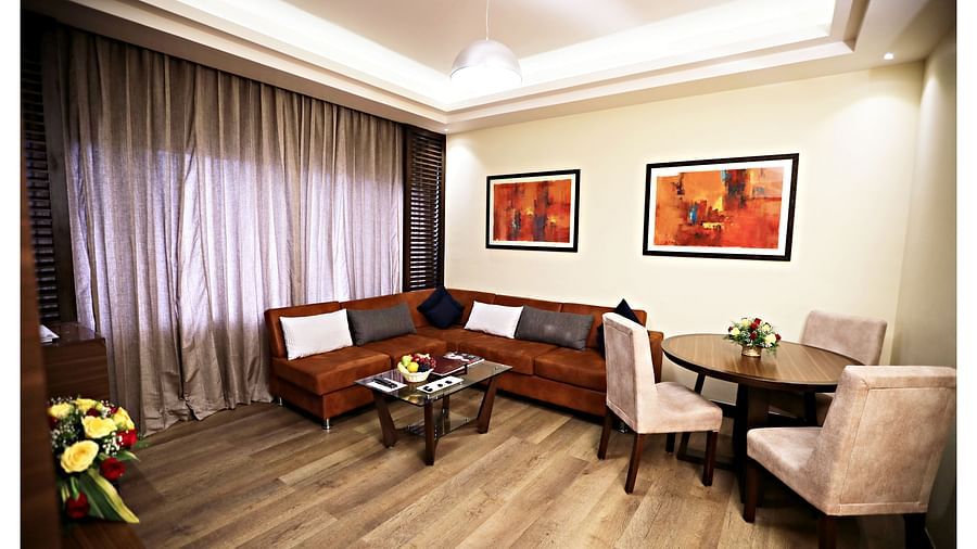 the living area with a TV and sofa sets at Executive Suites in Visakhapatnam 2